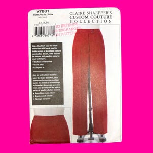 May include: A sewing pattern envelope for Claire Shaeffer's Custom Couture Collection, model V7881, featuring a pair of red trousers and a matching skirt. The white packaging includes text, a barcode, and descriptions of the garment construction.