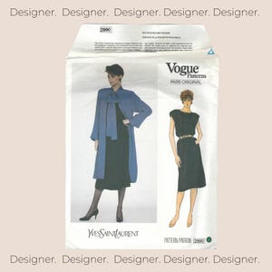 May include: A Vogue Patterns sewing pattern envelope, number 2990, featuring a Paris Original design by Yves Saint Laurent. The white envelope displays illustrations of a blue coat over a black dress and a black dress with a belt, with text.