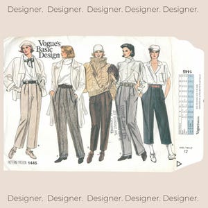 May include: A Vogue Basic Design sewing pattern envelope, number 1445, featuring illustrations of five outfits including blazers, trousers, a turtleneck sweater, and blouses. The white paper envelope displays text, size charts, and fashion sketches.