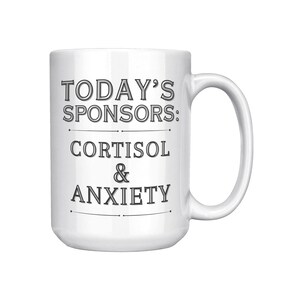 May include: White ceramic coffee mug with black text that reads "TODAY'S SPONSORS: CORTISOL & ANXIETY".