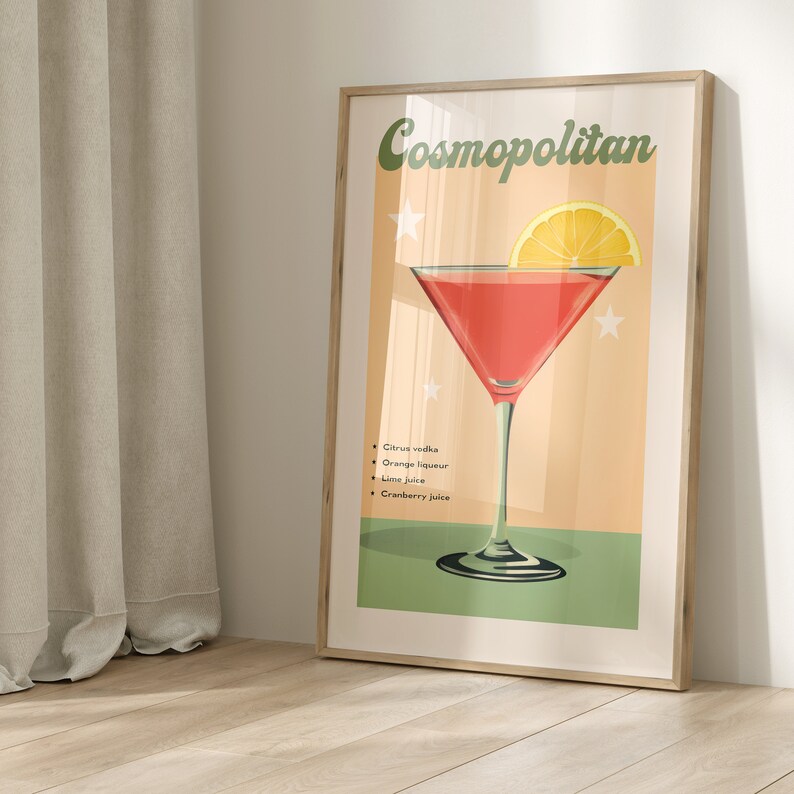 May include: A vintage-style poster featuring a red Cosmopolitan cocktail in a martini glass. The poster has a peach background with green accents and the text "Cosmopolitan" in a retro font. The ingredients are listed below the glass: citrus vodka, orange liqueur, lime juice, and cranberry juice.
