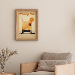 May include: A vintage-style illustration of a Whiskey Sour cocktail. The image features a glass filled with a yellow liquid, a cherry, and an orange slice. The text "Whiskey Sour" is written in a retro font at the top of the image. The ingredients are listed below: Bourbon whiskey, lemon juice, simple syrup, and egg white.