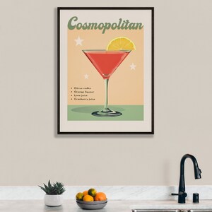 May include: A vintage-style poster with a cocktail recipe for a Cosmopolitan. The poster features a martini glass filled with a red cocktail and a lemon wedge garnish. The text "Cosmopolitan" is in a retro font and the ingredients are listed below: Citrus vodka, Orange liqueur, Lime juice, Cranberry juice.