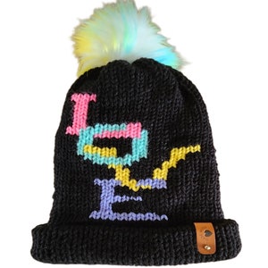 May include: Black knit beanie with a multi-colored pom pom and the word "LOVE" knitted in colorful yarn.