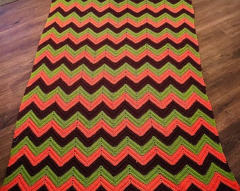 Vintage 1970’s hand made chevron knit blanket. 8 feet long by 50 inches. orange green and brown