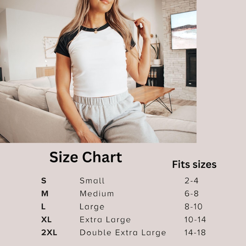 May include: A white raglan t-shirt with black sleeves and a black collar is shown. The model is wearing gray sweatpants. A size chart is displayed below the model, with sizes ranging from S to 2XL, and corresponding US sizes.