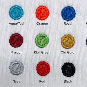 May include: A white fabric with embroidered circles in a range of colours. The colours include Flamingo, Aqua/Teal, Orange, Royal, and Kelly Green. Other colours are Gold, Maroon, Kiwi Green, Old Gold, Navy, Purple, Grey, Red, Black, and White.