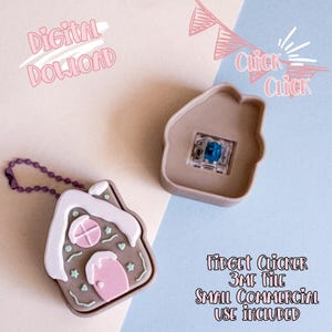 May include: A gingerbread house-shaped fidget clicker with a pink door, white frosting, and green accents. The clicker is attached to a purple chain. The image also includes a separate house-shaped case and text that reads "Digital Download".