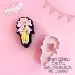 May include: A black, yellow, and white pencil-shaped charm with a bow, and a white fidget clicker mold. The image includes the text "Digital Download" and "Fidget Clicker 3MF File Small Commercial Use Included" on a pink background.