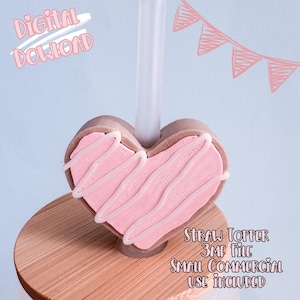 May include: A heart-shaped straw topper with pink frosting and white icing detail. The topper is on a clear straw, and the image includes the text "Digital Download" and "Straw Topper 3MF File Small Commercial Use Included."