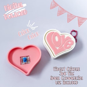 May include: Pink heart-shaped fidget clicker with a blue switch and a white and pink heart-shaped keychain with the word "Love". The image also includes the text "Digital Download" and "Click Click".