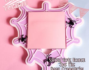 May include: A pink sticky note holder with a spiderweb design, featuring a pink sticky note pad and black spider accents. The holder has a white border and the text "Digital Download" is visible. The text "Sticky Note Holder" is also visible.