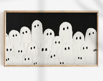May include: A framed Halloween-themed artwork featuring a crowd of white ghost figures with black eyes against a black background. The ghosts have a textured, painted appearance. The frame is a light brown color.