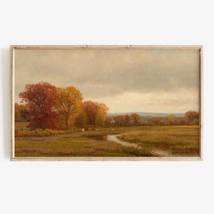 May include: An antique landscape painting in a wooden frame. The artwork depicts a serene autumn scene with a river, trees in vibrant red and yellow hues, and a cloudy sky. The painting evokes a sense of tranquility.
