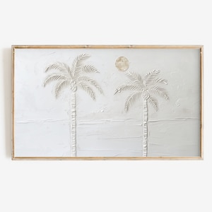 Peut inclure: Une peinture encadrée de deux palmiers blancs avec une lune blanche en arrière-plan. La peinture est sur une toile texturée blanche.