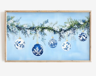 May include: A blue and white Christmas garland with five blue and white ornaments hanging from it. The garland is made of pine branches and is decorated with white berries. The ornaments are all different designs and are hanging from the garland with gold string.