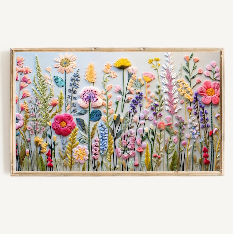 Textured Frame Tv embroidery artwork depicting a colorful field of flowers in shades of pink, purple, yellow, and green. The flowers are arranged in a dense, layered pattern, creating a sense of depth and texture.