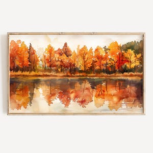 Puede incluir: Pintura acuarela de una escena de bosque con árboles en tonos de naranja, amarillo y rojo reflejados en un lago tranquilo. Los árboles están en otoño.