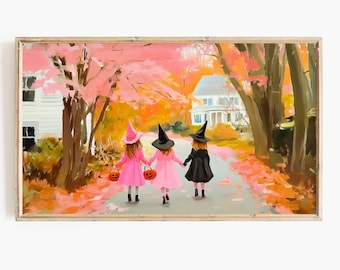 May include: Three children dressed as witches walk down a path lined with autumn leaves. They are wearing black witch hats and pink dresses. The children are carrying orange pumpkin pails.