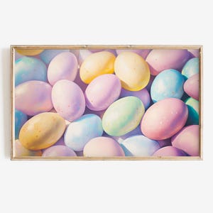 May include: A close-up of a group of pastel-colored Easter eggs. The eggs are arranged in a random pattern and are all different shades of pink, blue, green, and yellow.