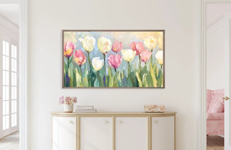 May include: A framed painting of a bouquet of pink, white, and yellow tulips with green leaves against a light blue background.