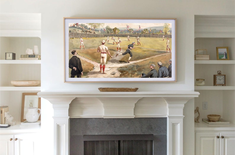 May include: A framed vintage illustration of a baseball game in progress. The players are wearing white uniforms with red accents. The field is green and the background shows a town with trees and buildings.