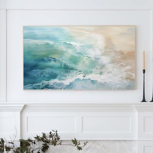 May include: Abstract painting of ocean waves in shades of blue, green, and white. The painting is framed and hanging on a white wall above a white fireplace.