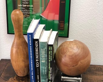 A wooden "bowling ball" and actual pin from the collection of Stephen Sondheim