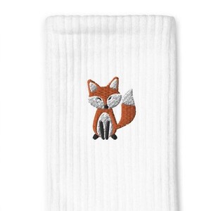 May include: White socks with an embroidered orange fox design.