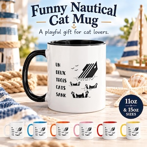 Puede incluir: Una taza de cerámica blanca con asa e interior negros, que presenta un gráfico de un barco hundiéndose y tres gatos en el agua. El texto dice: UN DEUX TROIS CATS SANK. La taza está disponible en tamaños de 11oz y 15oz, según el texto.