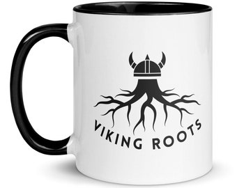 May include: White ceramic mug with a black rim and handle. The mug features a black and white graphic of a Viking helmet with roots growing from the base. The text "VIKING ROOTS" is printed below the graphic.