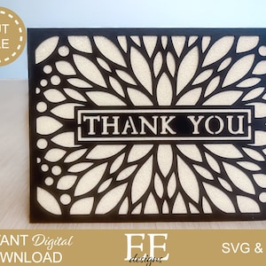 Puede incluir: Tarjeta de agradecimiento en blanco y negro con un dise&ntilde;o floral. La tarjeta tiene un dise&ntilde;o recortado de hojas y c&iacute;rculos. Las palabras "Gracias" est&aacute;n en el centro de la tarjeta.