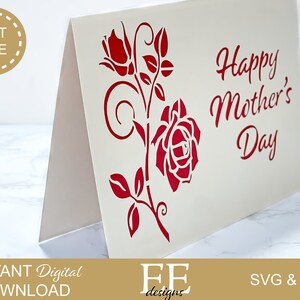 May include: A white card with a red rose and leaves design. The text "Happy Mother's Day" is written in red.