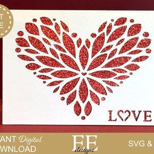 May include: A white card with a red glitter heart design and the word "LOVE" in red lettering. The heart is made up of many small leaves.