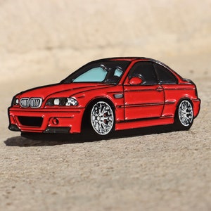 May include: A red enamel pin of a BMW M3, a popular sports car model. The pin is detailed with black accents and white wheels.