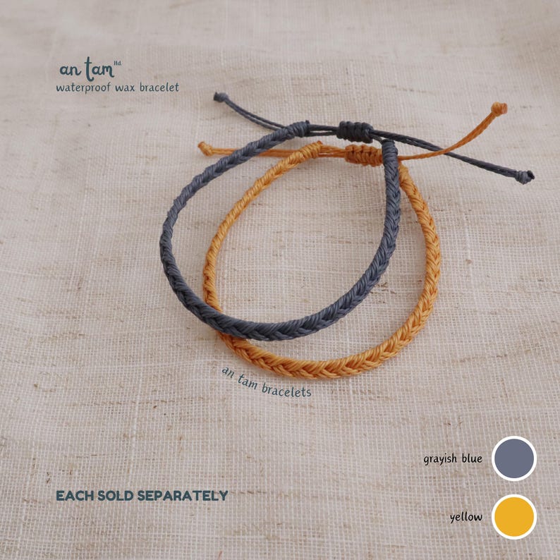 May include: Two braided waterproof wax bracelets, one greyish blue and one yellow. The bracelets have adjustable knots. The image text reads "an tam waterproof wax bracelet" and "an tam bracelets".