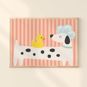 May include: A framed print featuring a cartoon Dalmatian dog with a chef's hat and a yellow rubber duck. The dog is white with black spots and a light blue collar. The background has vertical pink and peach stripes.