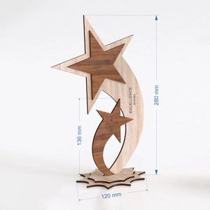May include: Wooden star-shaped award with a light wood and dark wood grain design. The award is 280 mm tall, 136 mm wide, and 120 mm across the base. The text "Excellence Award" is visible.