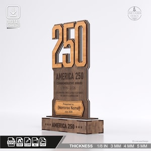 May include: A wooden commemorative award with the number "250" at the top. The text "AMERICA 250 COMMEMORATIVE AWARD 1776-2026" is displayed below the number. The award is 1/8 inch thick.