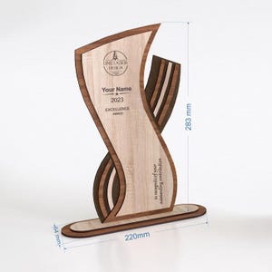 May include: A wooden award with a light wood grain finish, featuring the text "LINE LASER DESIGN", "Your Name", "2023 EXCELLENCE AWARD", and "in recognition of your outstanding contribution". The award is 220mm wide, 64mm deep, and 283mm tall.