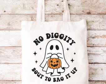 May include: White canvas tote bag featuring a ghost holding a jack-o'-lantern and the text "No Diggity Bout To Bag It Up".