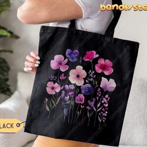 May include: Black tote bag with a watercolor floral design featuring pink, purple, and blue flowers on a black background.