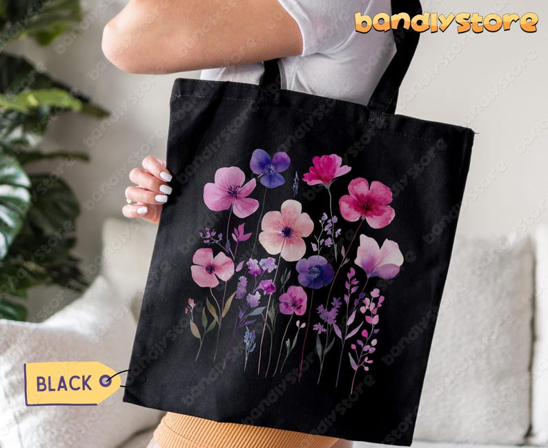 May include: Black tote bag with a watercolor floral design featuring pink, purple, and blue flowers on a black background.