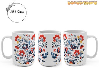 May include: White ceramic mug with a floral design featuring red, blue, and yellow flowers on a white background. The design wraps around the mug, and the text "All 3 Sides" is visible on the mug.