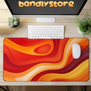 May include: A red, orange, and yellow abstract design mousepad with a white mouse on top. The mousepad has a wavy, layered pattern.