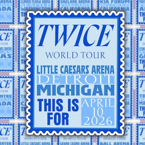 May include: A blue and white concert poster for the TWICE World Tour at Little Caesars Arena in Detroit, Michigan. The poster includes the date: April 10, 2026. The design is framed with a blue postage stamp border.