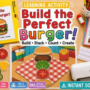 May include: A learning activity set titled Build the Perfect Burger featuring a yellow instruction booklet, a stack of challenge cards, blue scissors, a white laminator, and various paper burger ingredient cutouts including lettuce, tomato, and pickles.