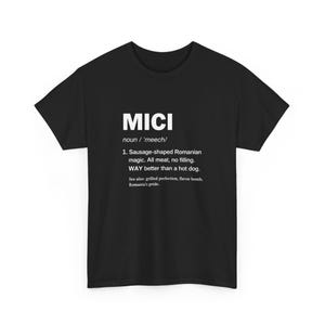 May include: Black t-shirt with the word "MICI" in white, followed by a definition. The definition describes a sausage-shaped Romanian food, stating it's all meat, no filling, and better than a hot dog.