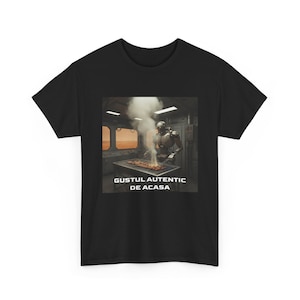May include: Black t-shirt featuring a graphic of a robot grilling food. The robot is standing over a grill with smoke rising. The text "GUSTUL AUTENTIC DE ACASA" is displayed below the image.