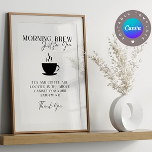 May include: A printable sign with the text "Morning Brew Just for You" and a black and white illustration of a coffee cup with steam. The text below the illustration reads "Tea and coffee are located in the above cabinet for your enjoyment! Thank you".